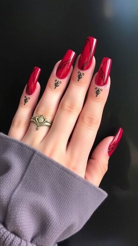 A hand with gothic cherry red nails, featuring a pointed shape and unique design.