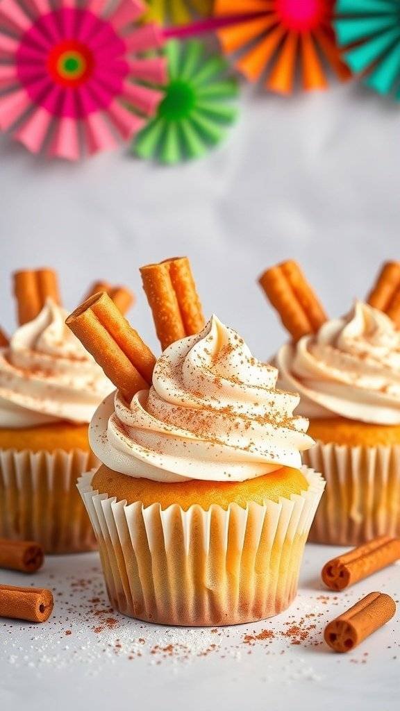 Churro cupcakes with cinnamon frosting and churro sticks on top, decorated with colorful paper fans in the background.