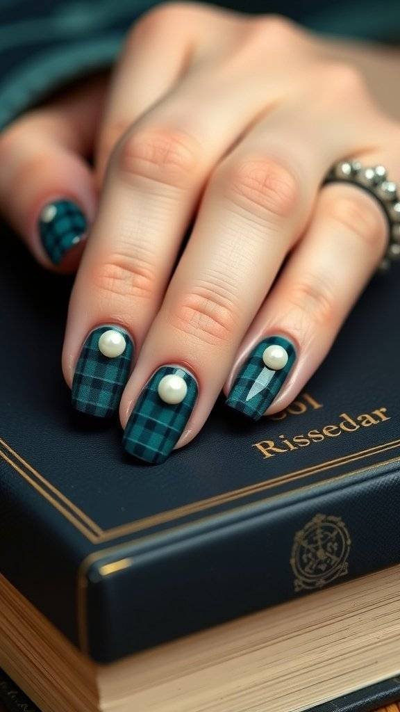 Nail art featuring deep teal plaid design with pearl accents, resting on an open book.