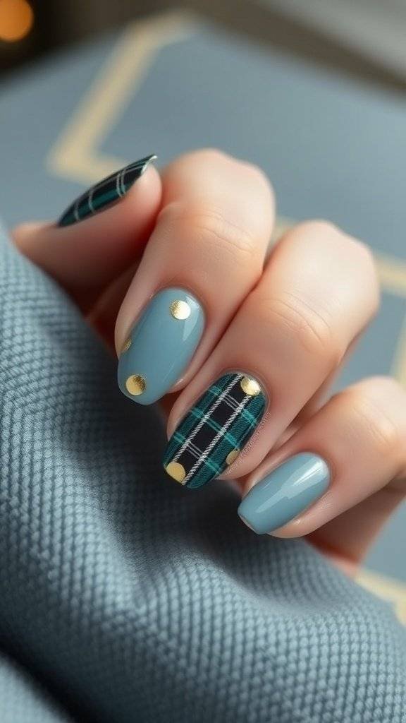 Nail art featuring dusty blue plaid patterns with gold foil accents, set against a dark background.