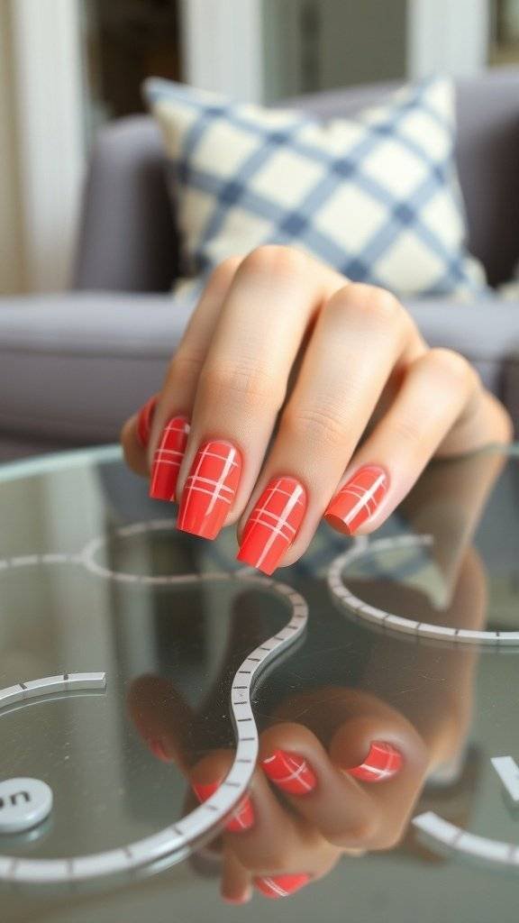 Nail art featuring bright coral plaid with silver lines on a table